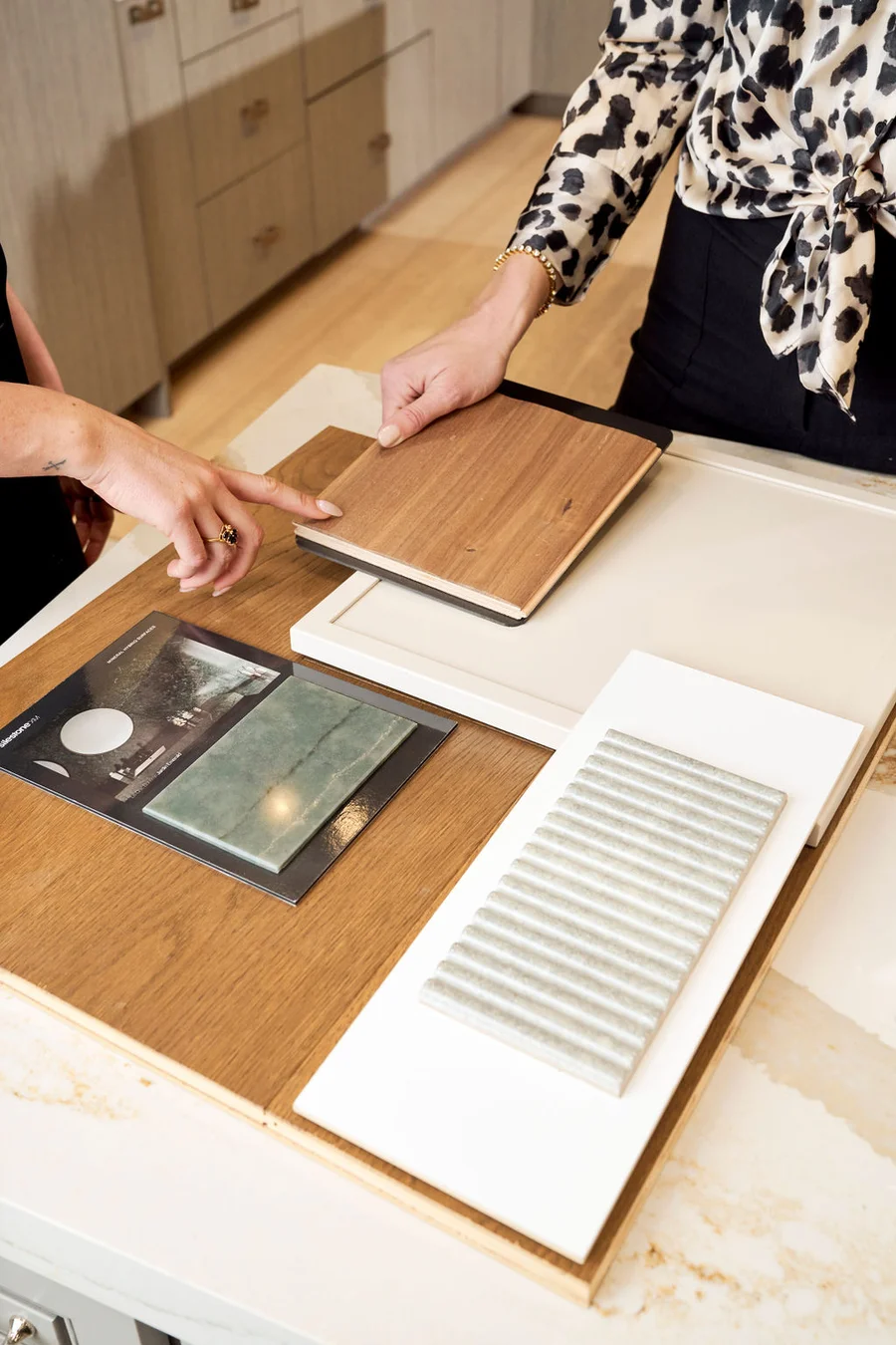 Brittany reviewing wood and tile material samples for a client project